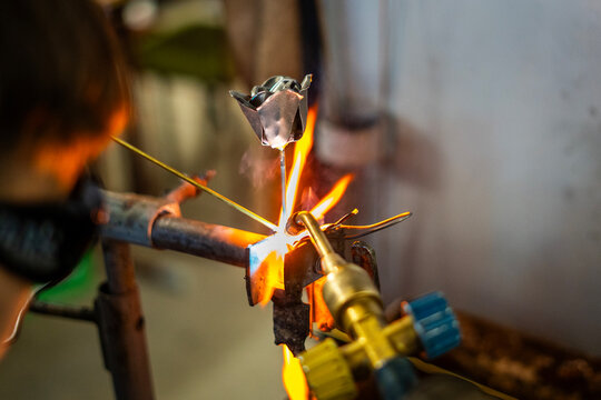 A craftsman welding a metal rose - Powered by Adobe