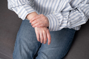 Woman feels pain in her body, touches her body with her knee, hands. Limb injury. Health concept