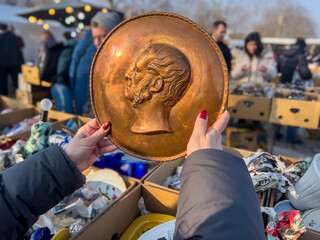 Interesting obejcts and used goods in a open air flea market. People looking things which they like.