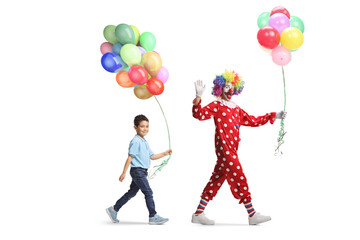 Boy and clown holding balloons and walking