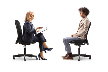 Obraz premium Man and woman sitting in office chairs, job interview concept