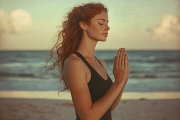 Redhead woman meditates peacefully on a sandy beach at sunset, finding serenity and inner peace.