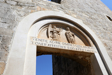 Latin Inscription and Stone Relief on Archway of St. Mary’s Benedictine Monastery in Dubrovnik, Croatia