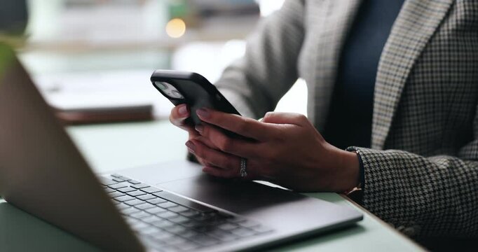 Business woman, hands and phone at laptop with networking, text and online communication. Desk, mobile message and social media browse in office or workplace with contact and typing at company