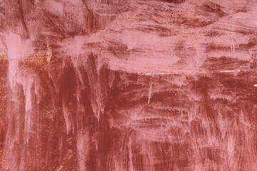 Textured metal surface featuring strokes of pink and copper tones