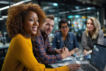 Woman with laptop leading a meeting with colleagues in a modern office environment setting seen smiling