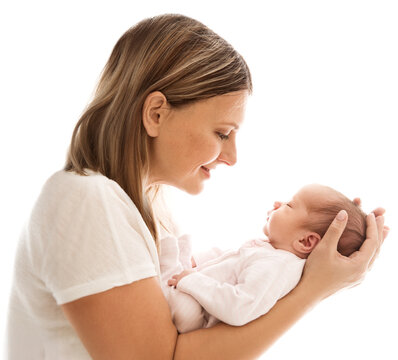 Happy Mother looking at Baby. Smiling Mom holding Newborn in Hand side view over white background. Childbirth and Child Health Care. Mother's day. Mother Love Baby