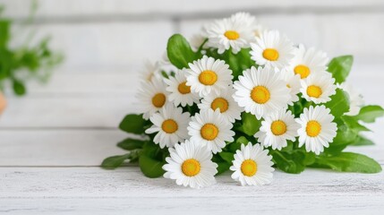 Obraz premium Delicate bouquet of daisies on a white wooden surface