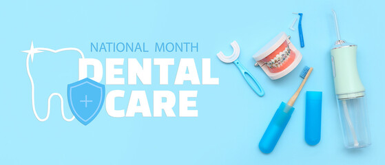 Jaw model with oral irrigator and toothbrushes on blue background