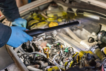 Mechanic Man Fixing Car in Workshop