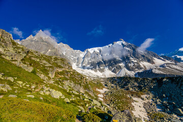 Fototapeta premium Aiguille du Midi peak in the Alps. Chamonix valley landscape of a prominent rocky towering mountain peak in French Alps. Chamonix-Montblanc area beautiful landscape of Aiguille du Midi summit, France
