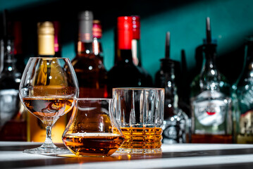 Strong hard alcoholic drinks, spirits, distillates, whiskey and others in glasses and bottles....