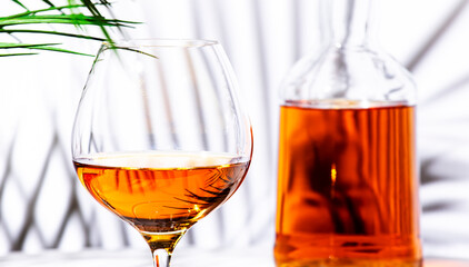 Spanish Brandy in glass with bottle on white background