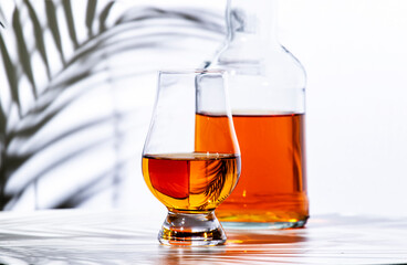 Scotch whisky in glencairn glass for tasting and bottle  n white background