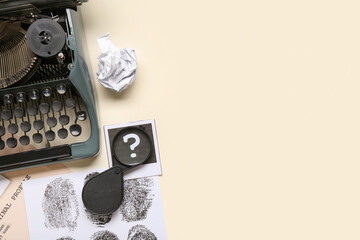 Retro typewriter, magnifier and fingerprints on light background