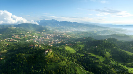 Naklejka premium Aerial View Of Lush Green Valley Town With Hills And Ocean