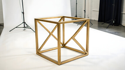 modern gold cube frame with minimalist design, showcasing geometric lines and sleek finish, perfect for contemporary decor