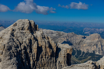 Dolomites, Alpi Dolomiti beautiful scenic mountain landscape under blue sky in summer. Rocky tower peak summits of the Alps on a sunny day. Alpine scenic view of the cliffs and climbing walls in Italy