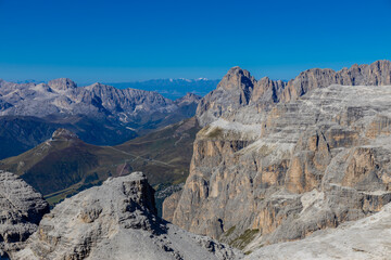 Dolomites, Alpi Dolomiti beautiful scenic mountain landscape under blue sky in summer. Rocky tower peak summits of the Alps on a sunny day. Alpine scenic view of the cliffs and climbing walls in Italy