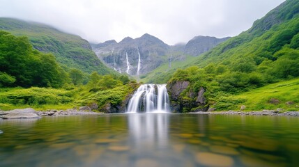 Fototapeta premium A serene waterfall cascading into a tranquil pool surrounded by lush green mountains, misty atmosphere with vibrant foliage, and natures peaceful beauty.