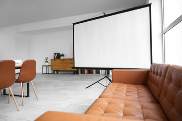 Interior of conference hall with projector screen and sofa