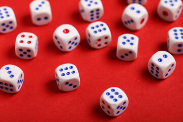 White game dices on red background, closeup