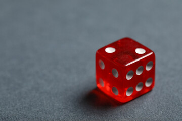 Red game dice on grey background