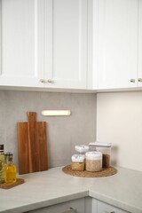 Glowing modern LED lamp on wall in kitchen