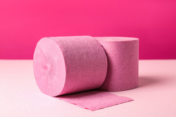 Color toilet paper rolls on pink background