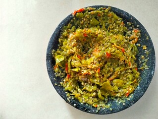 Top view. Green chili sauce on cuwek batu, one of the popular chili sauce in Indonesia.