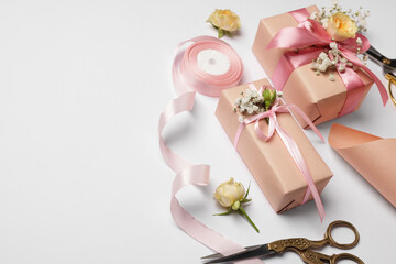 Florist. Boxes, flowers, scissors and ribbon on white background, space for text