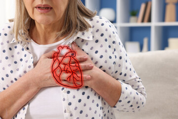 Senior woman suffering from heart attack indoors, closeup. Illustration of heart on chest