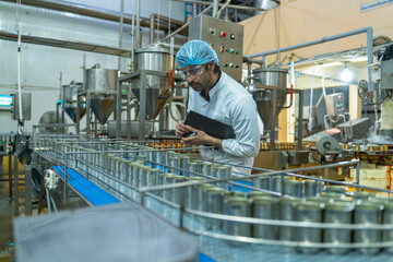 Technician performing detailed quality checks on a manufacturing line, highlighting industrial innovation, efficiency, and a commitment to high production standards.
