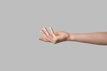 Female hand on light background