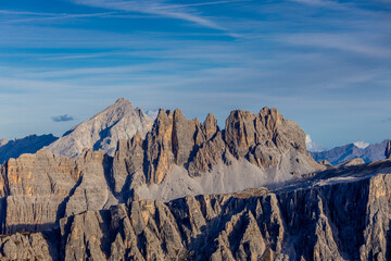Dolomites, Alpi Dolomiti beautiful scenic mountain landscape under blue sky in summer. Rocky tower peak summits of the Alps on a sunny day. Alpine scenic view of the cliffs and climbing walls in Italy