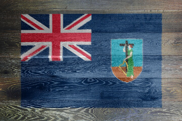 Montserrat flag on rustic old wood surface background