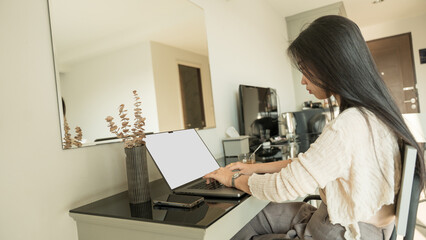 Asian woman freelancer with laptop empty screen in office. concept of business financial.