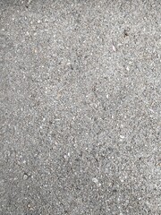 Close-up of a Textured Gray Asphalt Surface Showing Fine Aggregate Details