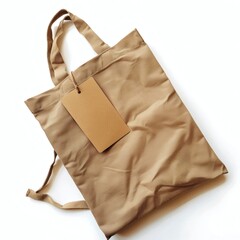 Naklejka premium Folded cotton tote bag with kraft tag on white background