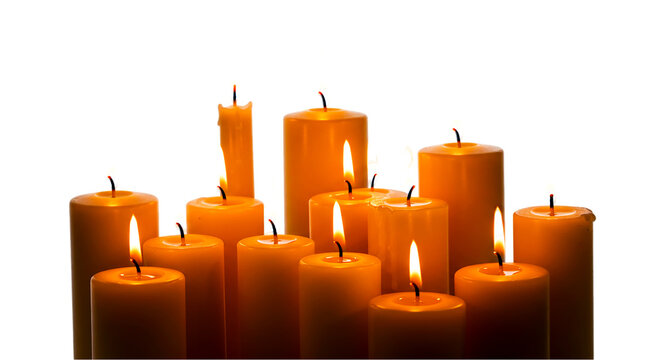 Group of lit candles with orange wax and flickering flames against a dark black background studio shot