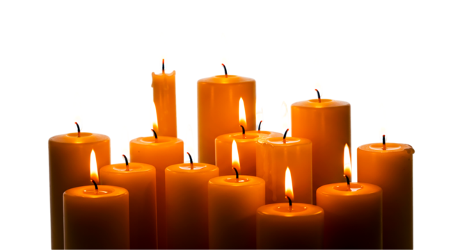 Group of lit candles with orange wax and flickering flames against a dark black background studio shot