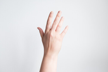 Caucasian adult female hand raised against white background