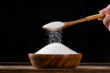 pure natural salt on wooden table.