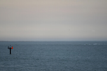 Calm Sea before storm with Distant red and green Buoy at dusk Chesapeake Bay