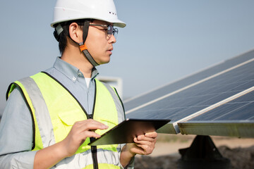 asian engineer working on digital tablet in solar power station