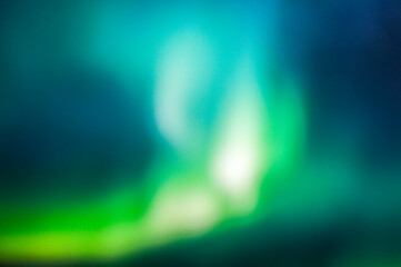 Cool blue green background created in camera with a lens with overlapping bokeh abstract soft edges light and dark areas with room for copy and text