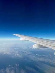 Obraz premium View from the cabin of airplane, clounds, land, sky.