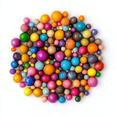Assorted colorful candy spheres scattered on a white surface 
