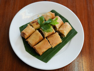 Egg rolls, Deep fried Chinese Chives Spring Rolls(Gui Chai) on a white plate.Thai snack food.