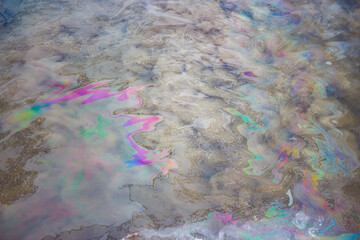 Rainbow colored film on the surface of the reservoir caused by illegal discharge of fuels and...